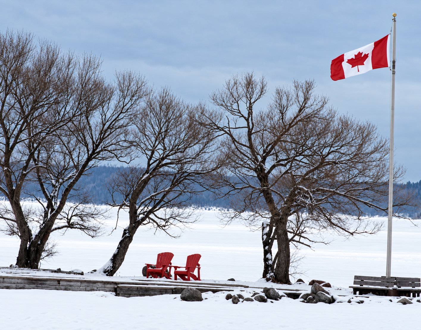 a Canadian flag and two red chairs in a snowy park